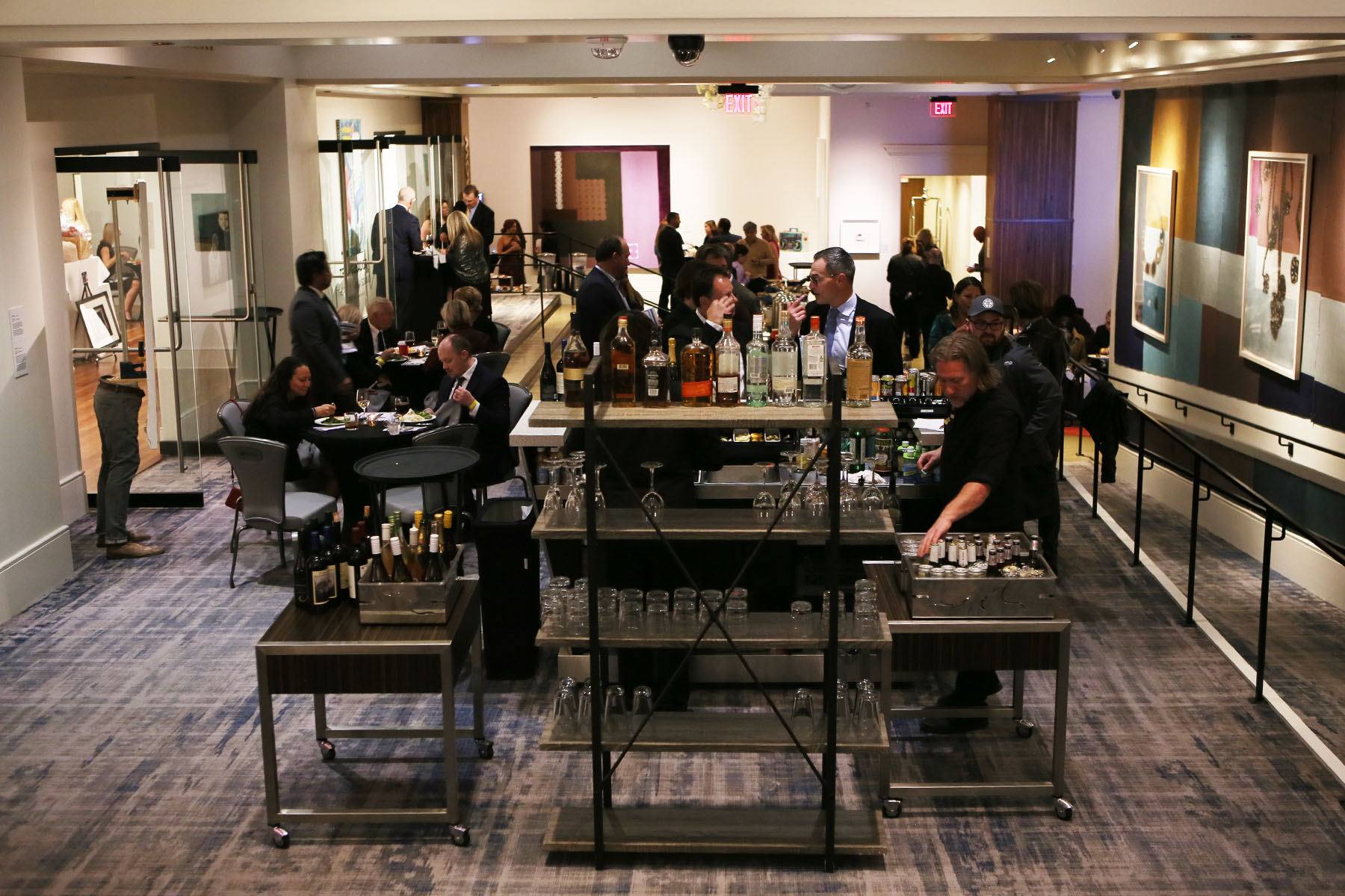 View of attendees mingling from behind the bar
