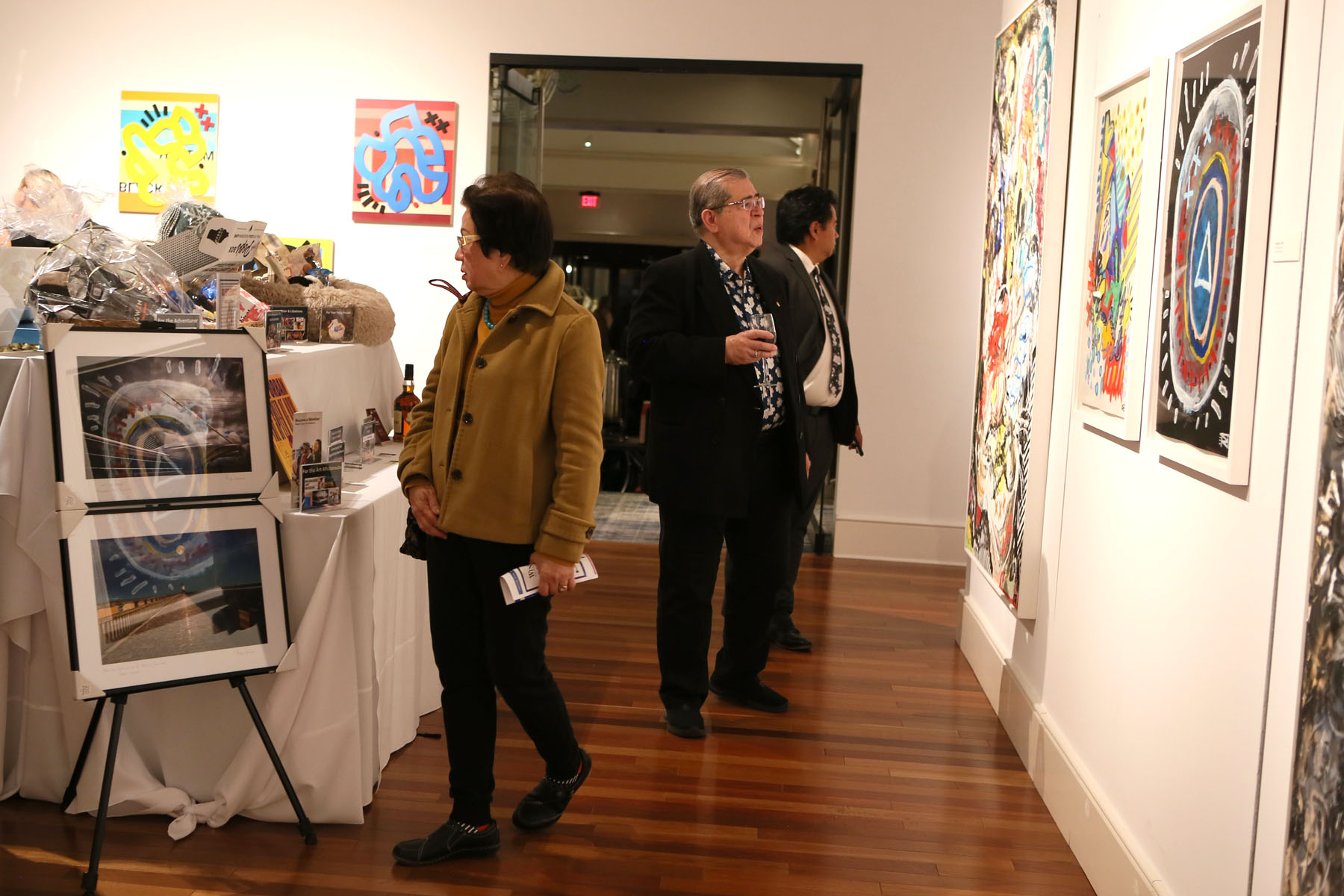 Guests peruse silent auction tables in the art gallery